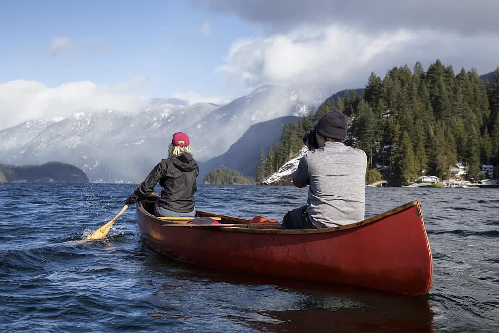 couple friends on a wooden canoe by canadian mount 2022 03 31 17 49 32 utc 1240x827 1
